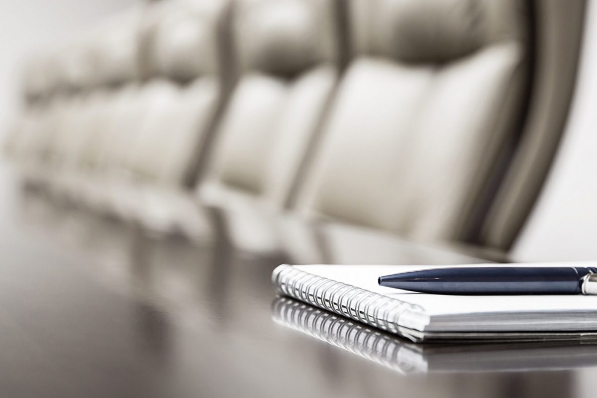 Notepad,On,Table,In,Empty,Conference,Room,With,Copy,Space